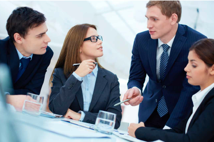 Business meeting at table with four people.